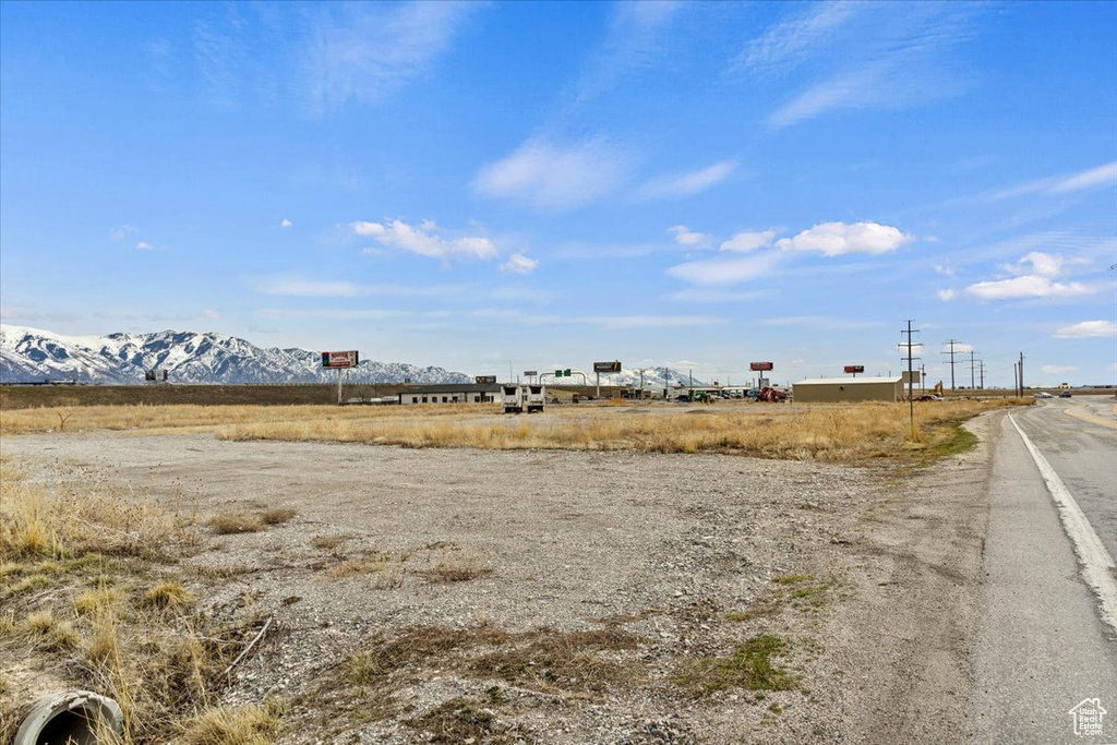 View of yard with a rural view and a mountain view