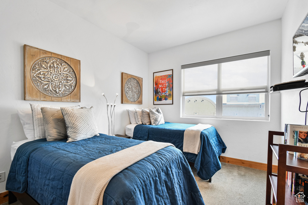 Carpeted bedroom featuring baseboards