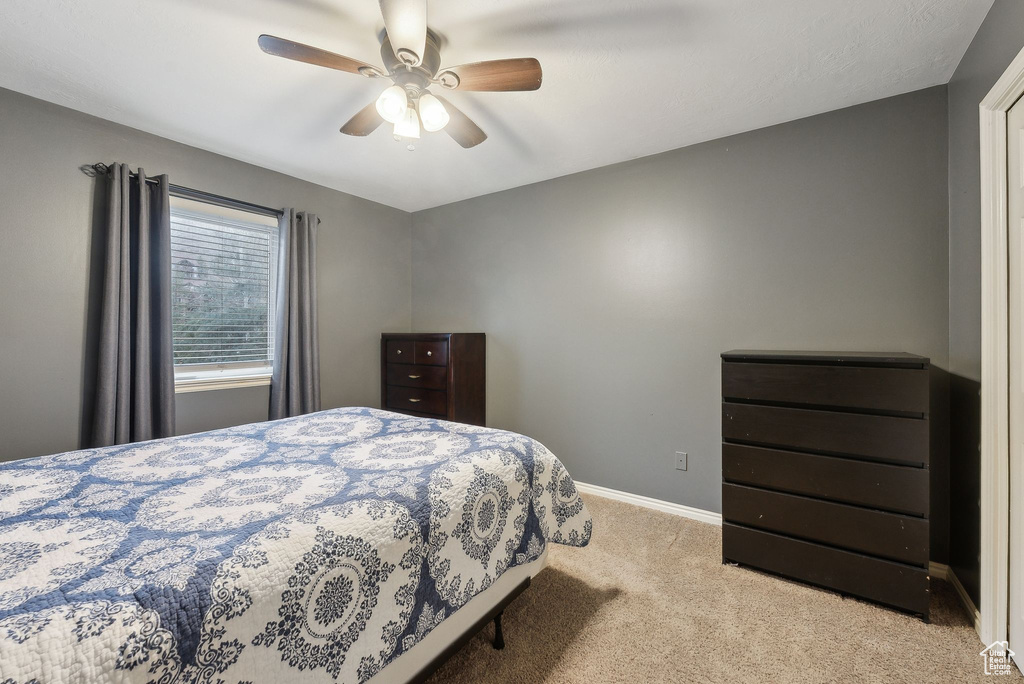 Bedroom featuring baseboards, carpet, and a ceiling fan