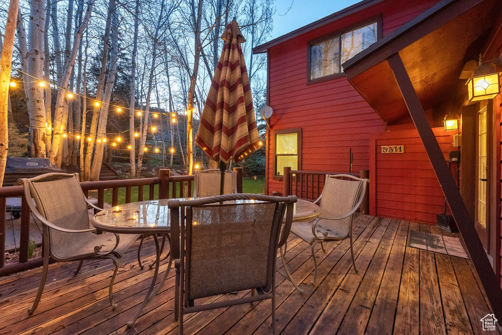 Wooden terrace featuring outdoor dining area