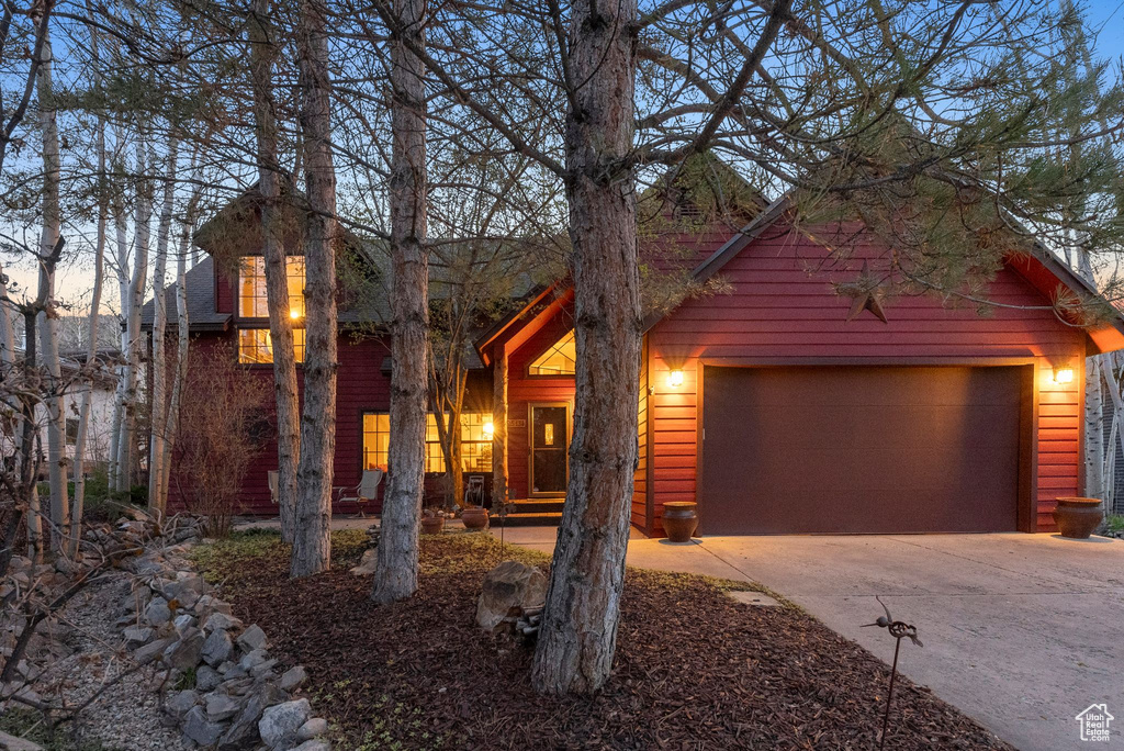 View of front of home featuring an attached garage and concrete driveway