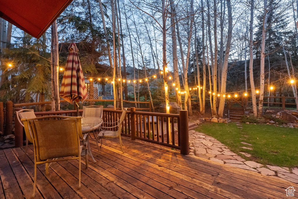 Deck featuring outdoor dining area and a yard