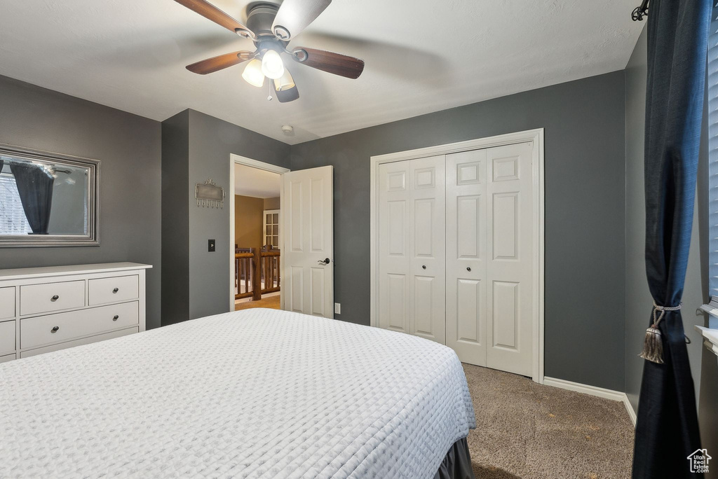 Bedroom with a ceiling fan, baseboards, carpet, and a closet