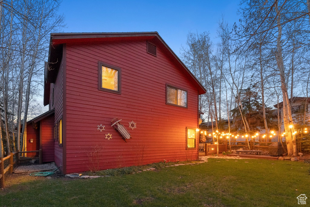 View of side of home featuring a lawn