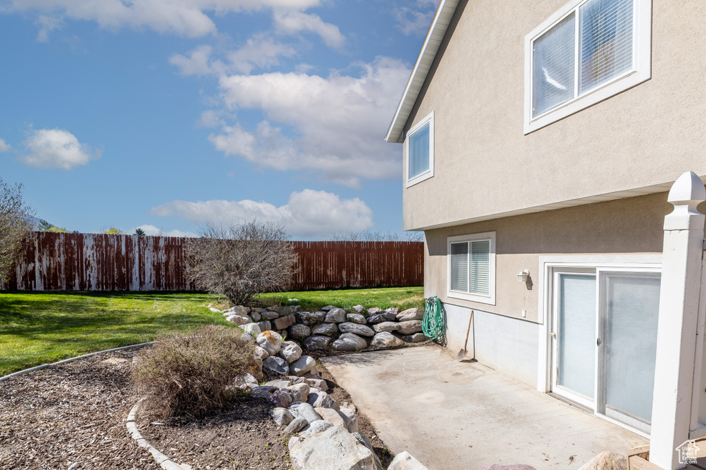 View of yard with fence and a patio