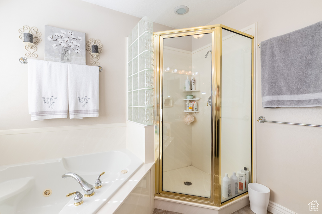 Bathroom with a jetted tub and a stall shower