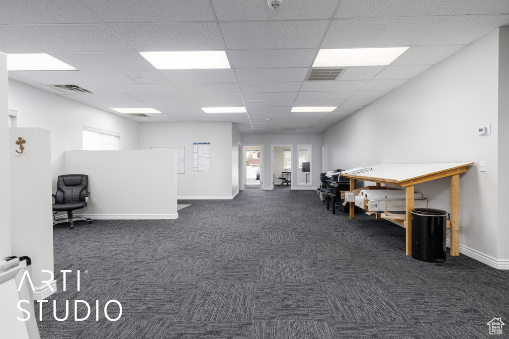 Misc room featuring visible vents, a drop ceiling, and dark colored carpet