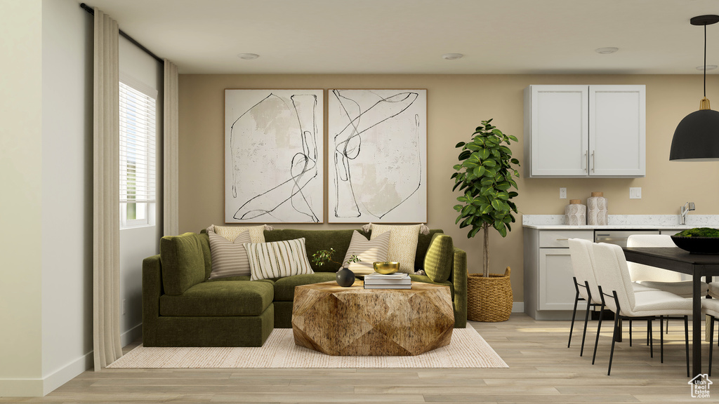 Living area with baseboards and light wood-style flooring