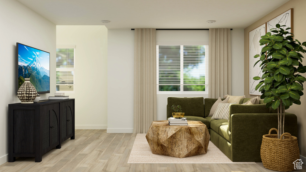 Sitting room with light wood-style floors and baseboards