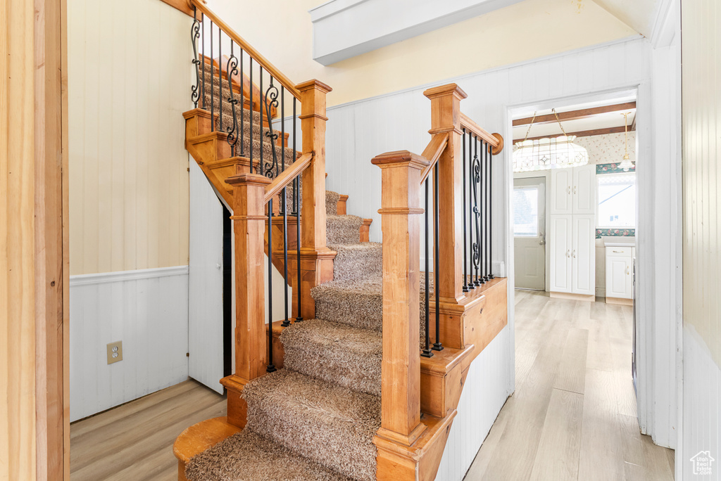 Stairs with wooden walls and wood finished floors