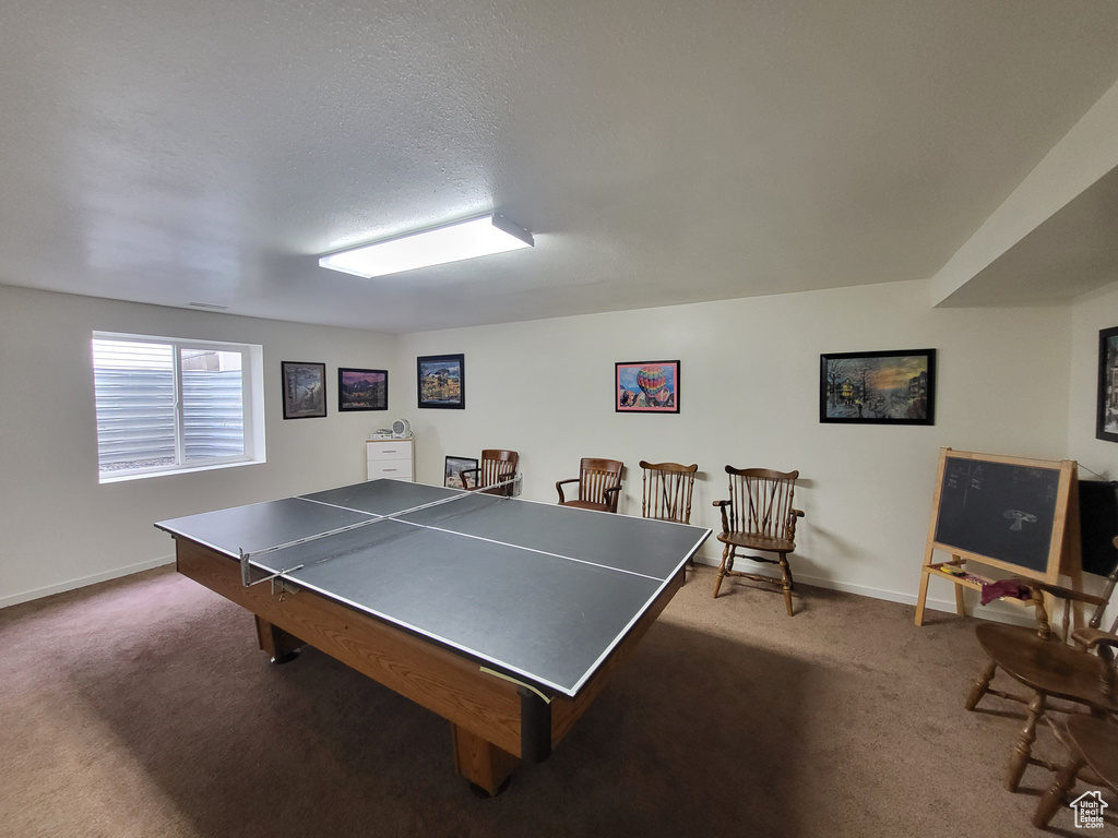 Game room with carpet flooring and baseboards