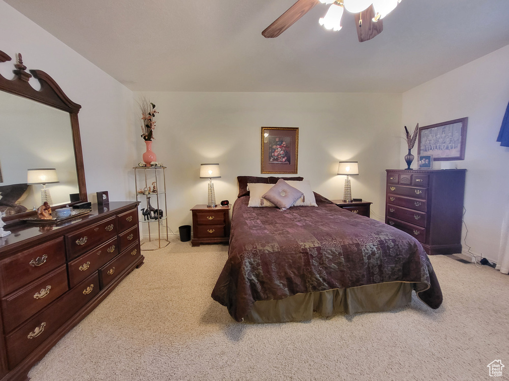 Bedroom featuring light carpet and a ceiling fan