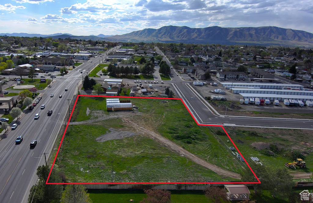 Birds eye view of property with a mountain view and a residential view