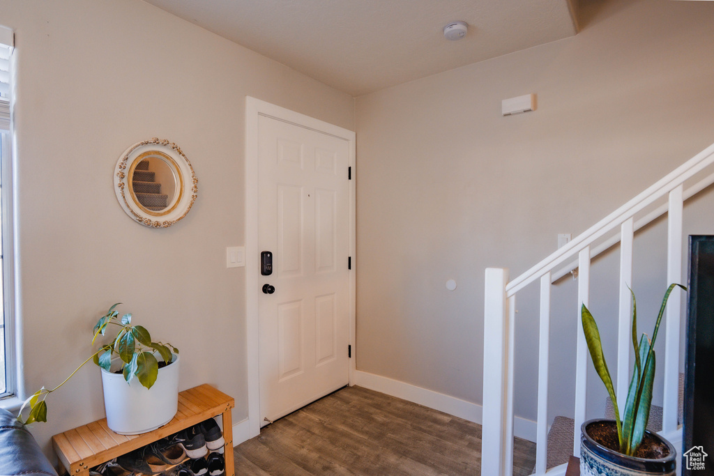 Foyer featuring baseboards and dark wood-style flooring