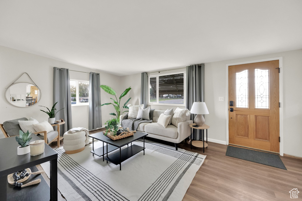 Living room with baseboards and light wood finished floors