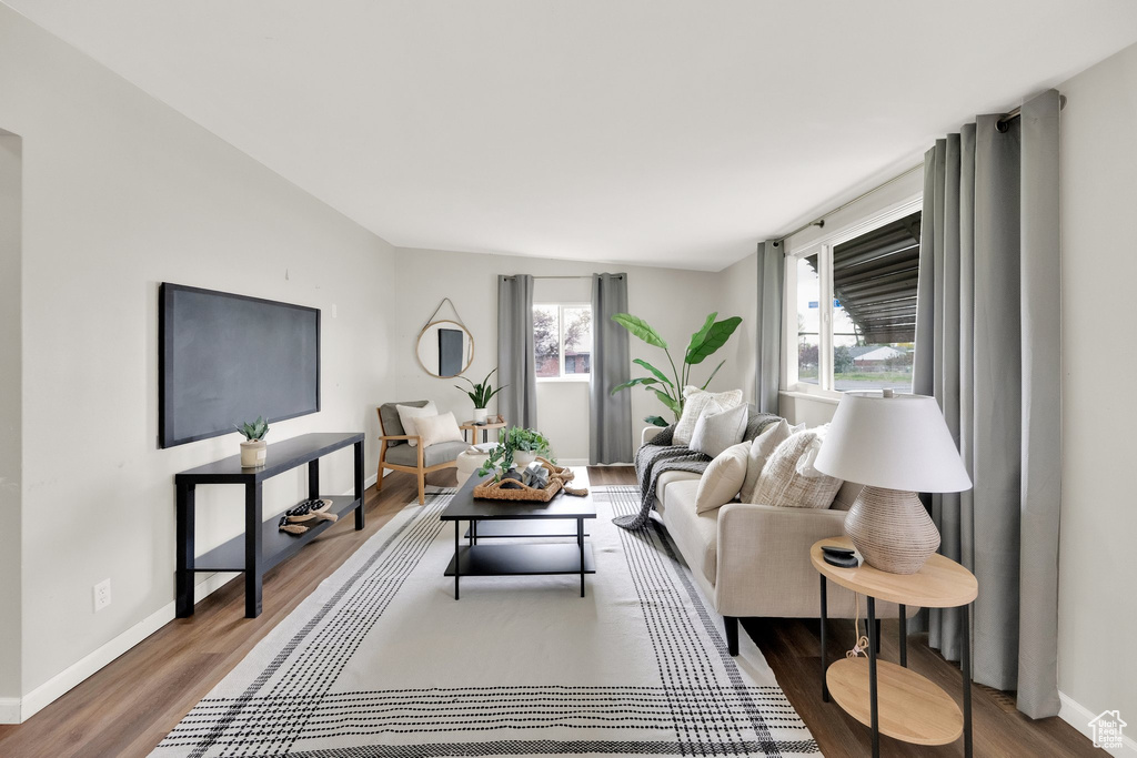 Living area with baseboards and wood finished floors