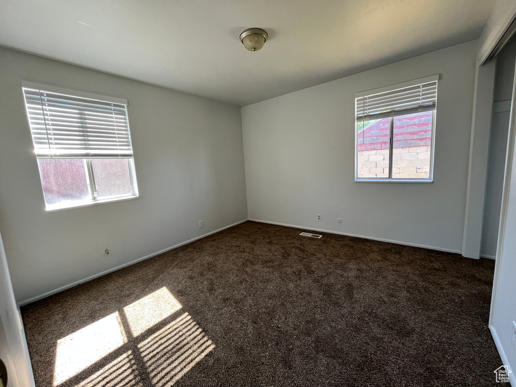 Interior space with carpet floors and baseboards