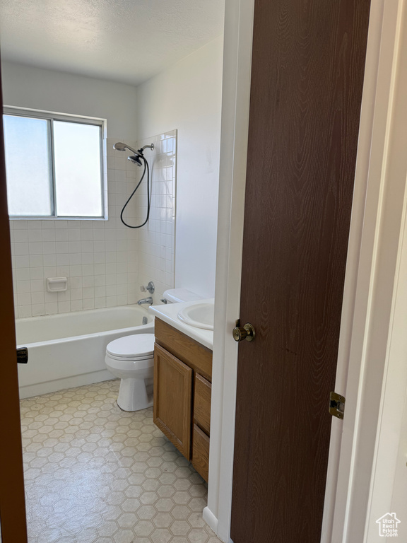Bathroom featuring bathing tub / shower combination, vanity, and toilet
