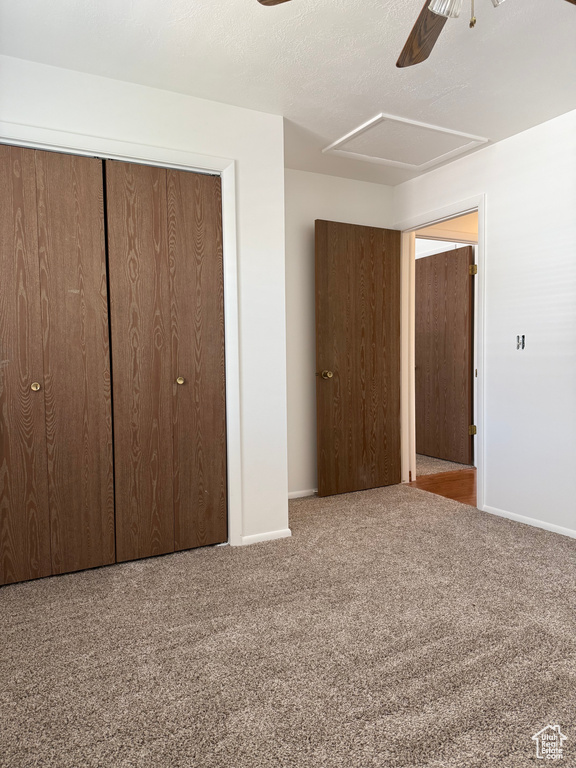 Unfurnished bedroom with baseboards, ceiling fan, a closet, and carpet flooring