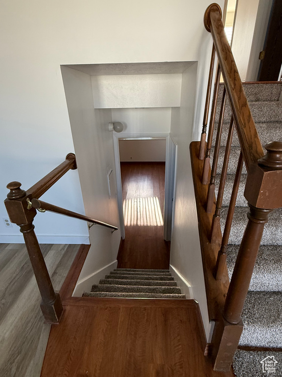 Stairs with baseboards and wood finished floors