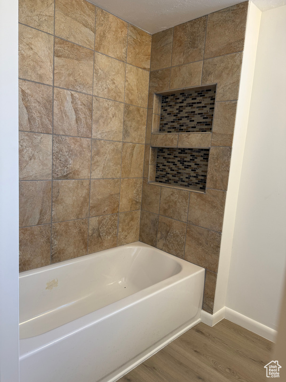 Full bathroom featuring baseboards and wood finished floors