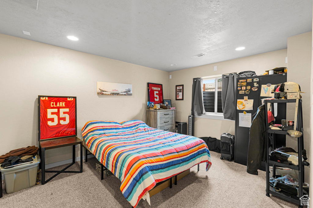 Bedroom with carpet floors, recessed lighting, a textured ceiling, and visible vents