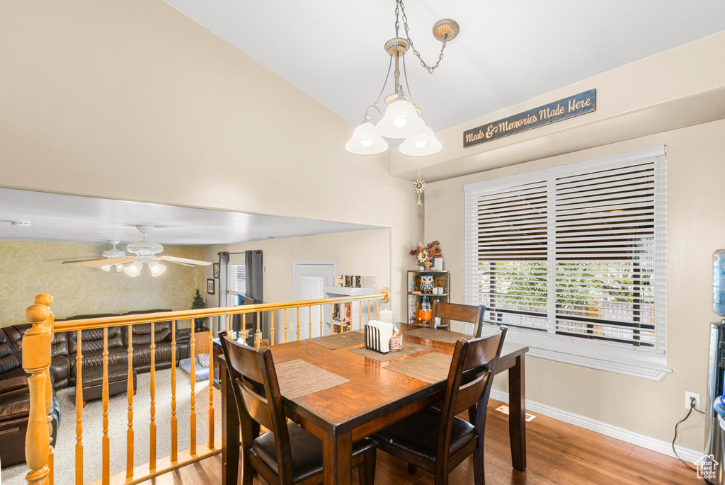 Dining space with a healthy amount of sunlight, baseboards, ceiling fan, and wood finished floors