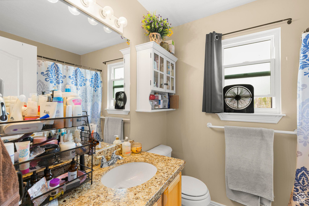 Bathroom featuring vanity and toilet