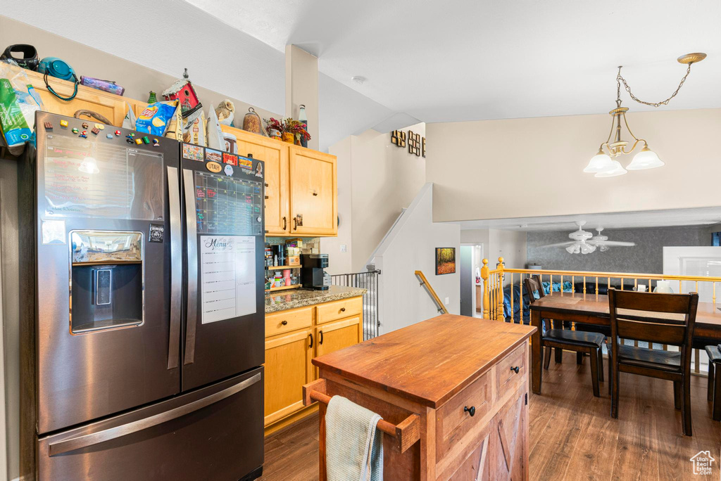 Kitchen with light brown cabinetry, a ceiling fan, lofted ceiling, dark wood-type flooring, and stainless steel refrigerator with ice dispenser