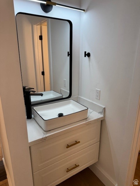 Bathroom featuring a sink and baseboards
