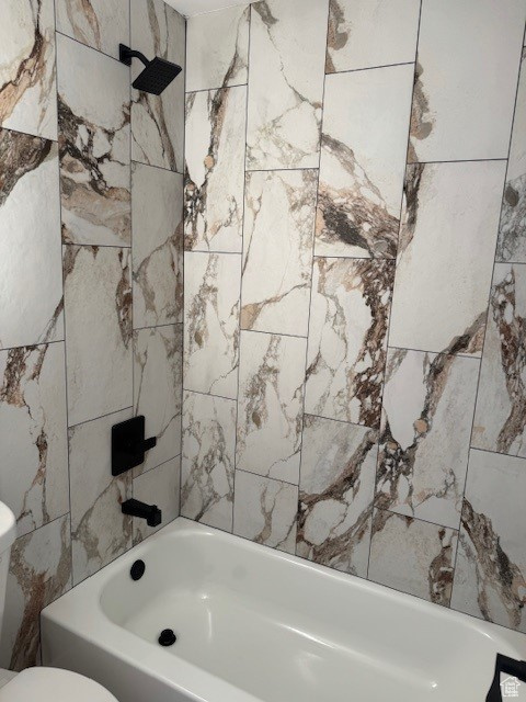 Bathroom featuring shower / bath combination and toilet