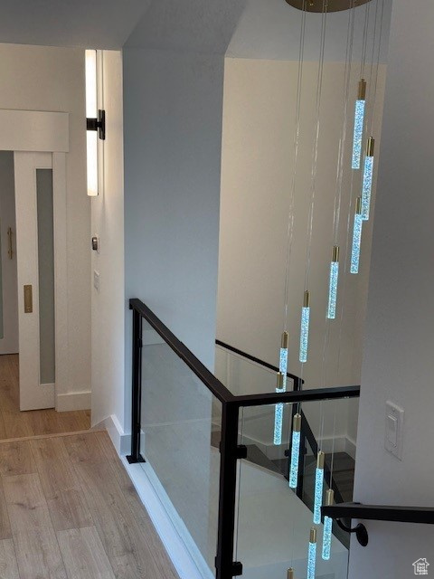Staircase with a healthy amount of sunlight, baseboards, and wood finished floors