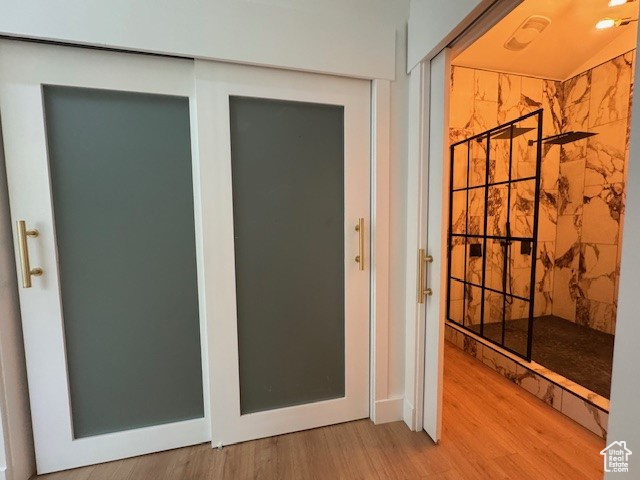 Interior space featuring wood finished floors and a tile shower