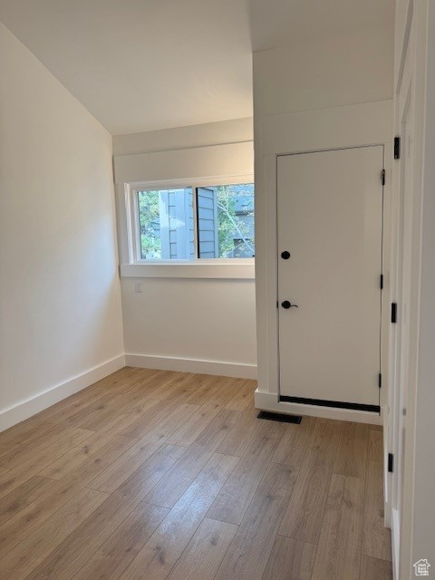 Interior space featuring baseboards, light wood-type flooring, and visible vents