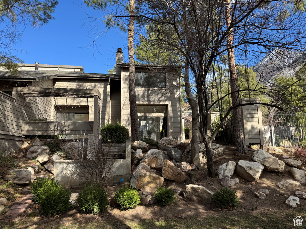 View of side of property featuring fence and a chimney