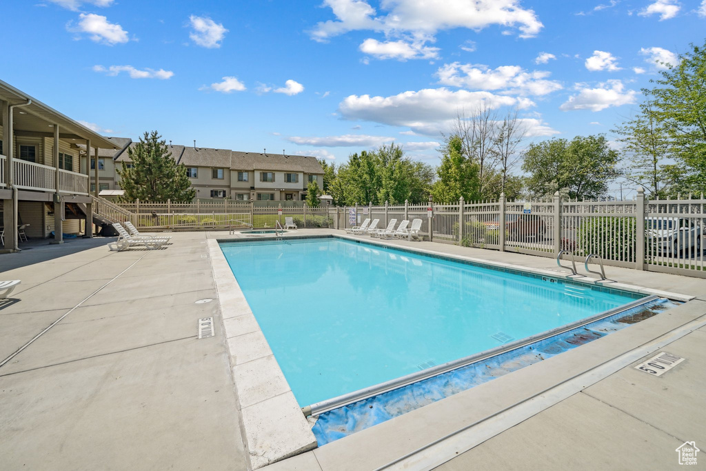 Community pool featuring stairs and a patio