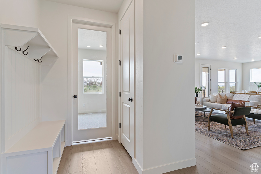 Mudroom featuring light wood-style floors, recessed lighting, and baseboards