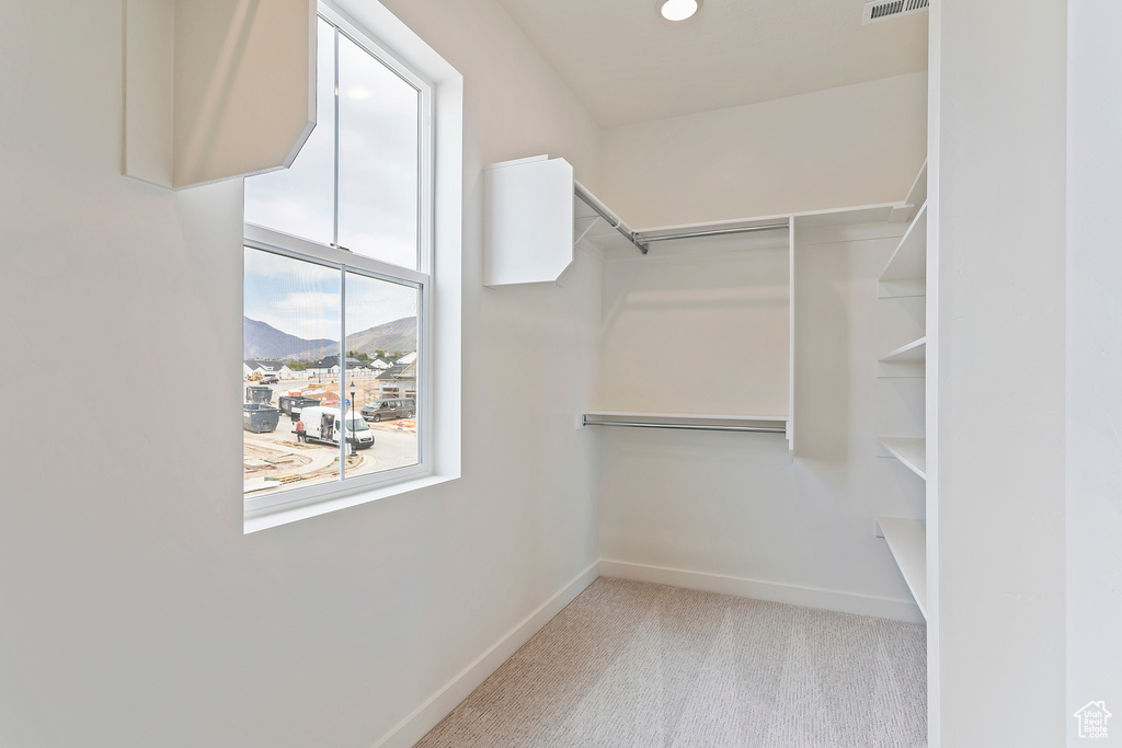 Walk in closet with carpet floors and visible vents
