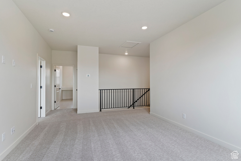Empty room featuring recessed lighting, baseboards, and light colored carpet