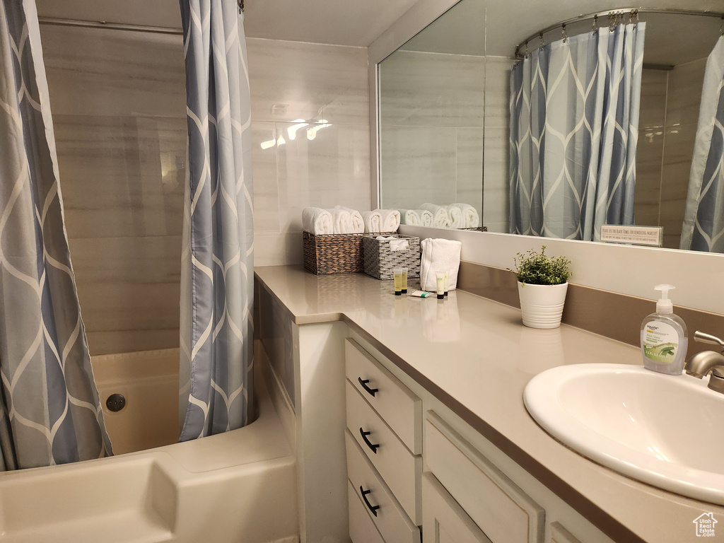 Full bath featuring vanity and shower / tub combo with curtain