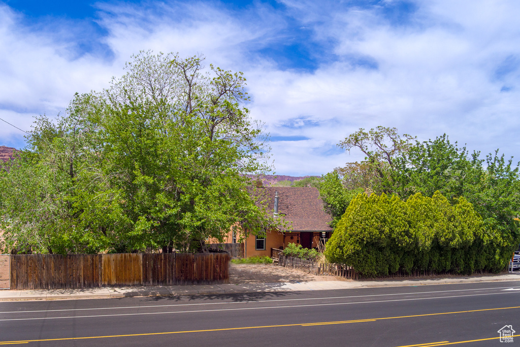 View of property hidden behind natural elements featuring fence