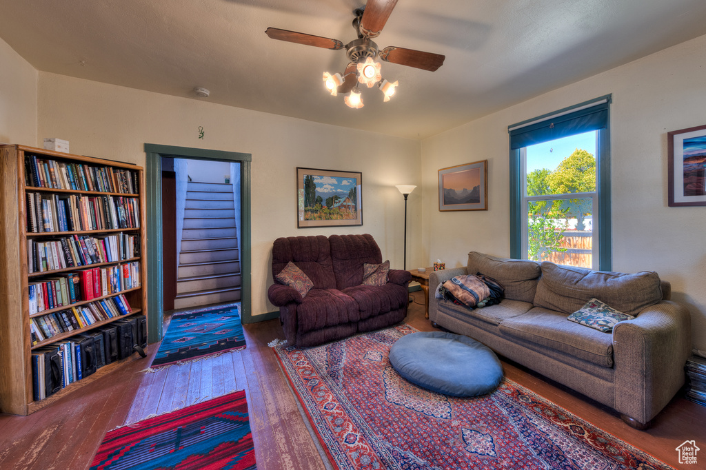 Living area with hardwood / wood-style floors and ceiling fan
