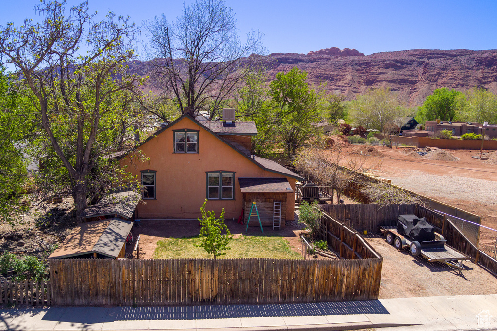 View of front facade with a fenced front yard and a mountain view