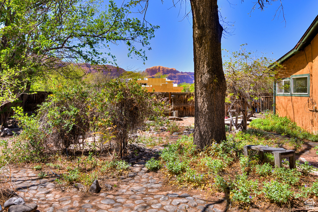 View of yard featuring fence and a mountain view