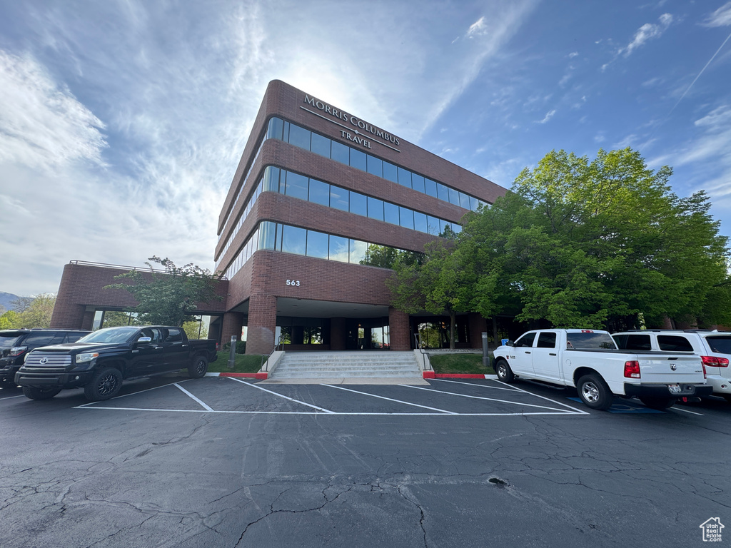 View of property featuring uncovered parking