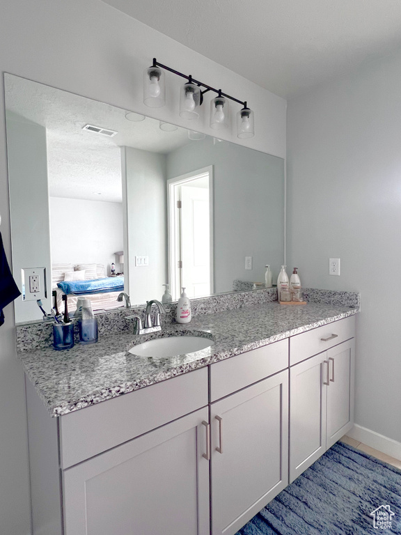 Bathroom featuring vanity, ensuite bathroom, and visible vents