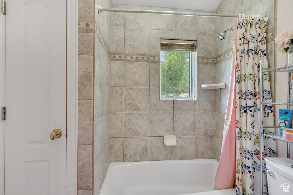 Bathroom with toilet and shower / bath combo