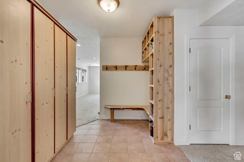 Mudroom with recessed lighting, baseboards, light tile patterned floors, and light carpet