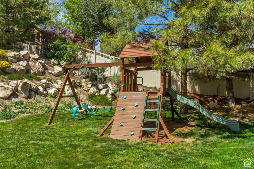 View of jungle gym with a lawn