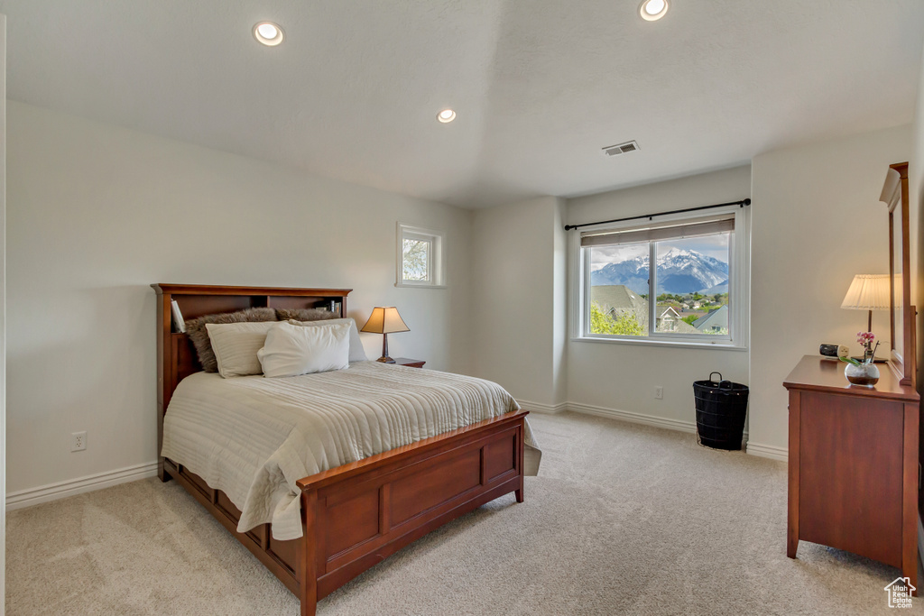 Bedroom featuring baseboards, light colored carpet, recessed lighting, and visible vents
